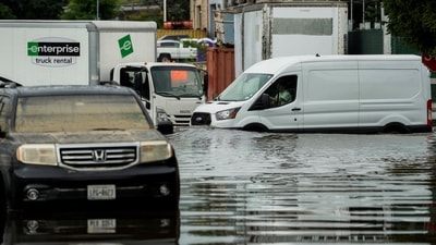 A van drives along a flooded street in the Elmsford area of Westchester, New York, U.S., July 15, 2025.  REUTERS/Eduardo Munoz (REUTERS)