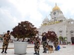 Security personnel with a sniffer dog frisk the surroundings of the Golden Temple in the wake of a fifth bomb threat, in Amritsar on Wednesday.
