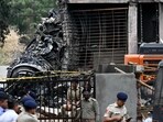 Police stand guard near the debris of Air India flight 171 after it crashed in a residential area near the airport in Ahmedabad on June 12. Police stand guard near the debris of Air India flight 171 after it crashed in a residential area near the airport in Ahmedabad on June 12.