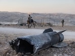 The remains of an Iranian missile lie near an Israeli settlement in the West Bank in the aftermath of the war. The remains of an Iranian missile lie near an Israeli settlement in the West Bank in the aftermath of the war.