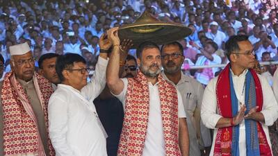 Congress leader Rahul Gandhi receives an Assamese Japi, a traditional headgear, during a party worker's meeting in Bangaon, west of Guwahati, on Wednesday. (AP) Congress leader Rahul Gandhi receives an Assamese Japi, a traditional headgear, during a party worker's meeting in Bangaon, west of Guwahati, on Wednesday. (AP)