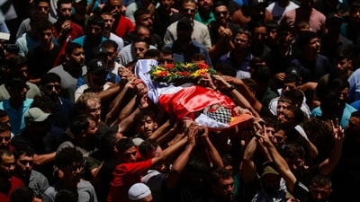 People carry the body of Sayfollah Kamel Musallet, a Palestinian-American man who was beaten to death by settlers, (REUTERS)