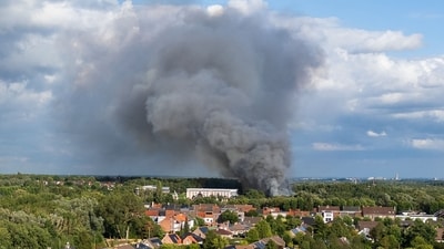 Smoke caused by a fire billows above the site of the Tomorrowland electronic music festival in Boom, northern Belgium on July 16, 2025. (AFP)