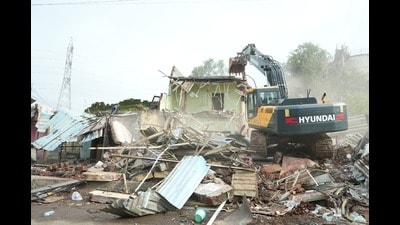 The operation targeted a 250-metre-long, 16-metre-wide stretch occupied by unauthorised huts, tin sheds, shops, and brick structures, which were cleared to make way for infrastructure development. (HT)