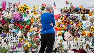 An elderly woman overlooks the photographs and notes that were left as an honour towards the lost lives during the deadly flash floods that battered Texas on July 4. (Brandon Bell/AFP) An elderly woman overlooks the photographs and notes that were left as an honour towards the lost lives during the deadly flash floods that battered Texas on July 4. (Brandon Bell/AFP)