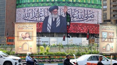 Motorists drive their vehicles past a billboard depicting Iran's Supreme Leader Ayatollah Ali Khamenei displayed in the centre of Tehran's Valiasr Square on July 13 (AFP) Motorists drive their vehicles past a billboard depicting Iran's Supreme Leader Ayatollah Ali Khamenei displayed in the centre of Tehran's Valiasr Square on July 13 (AFP)