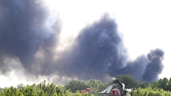 Smoke caused by a fire billows above the site of the Tomorrowland electronic music festival in Boom, northern Belgium on July 16, 2025.(AFP)