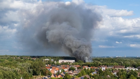 Smoke caused by a fire billows above the site of the Tomorrowland electronic music festival in Boom, northern Belgium on July 16, 2025.(AFP)