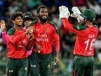 Mahedi Hasan celebrates a wicket with captain and wicketkeeper Litton Das during the T20I in Colombo.