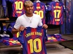 FC Barcelona player Lamine Yamal poses with his new jersey after signing a contract extension. FC Barcelona player Lamine Yamal poses with his new jersey after signing a contract extension.
