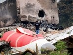 A firefighter stands next to the crashed Air India Boeing 787 Dreamliner aircraft, in Ahmedabad.