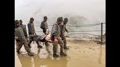 Army personnel rescue a pilgrim stranded due to heavy rainfall and landslides during the annual Amarnath Yatra, in Jammu and Kashmir. (PTI)