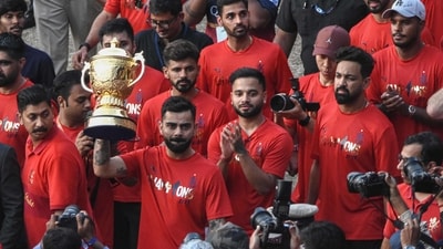 Virat Kohli and RCB players present the IPL trophy to the Bengaluru fans. (AFP) Virat Kohli and RCB players present the IPL trophy to the Bengaluru fans. (AFP)