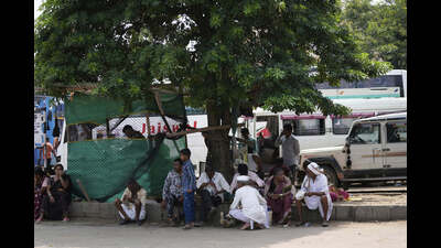 Stranded pilgrims rest under a tree as Amarnath Yatra, an annual pilgrimage to the Amarnath shrine, is halted amid heavy rain on the yatra track, in Jammu on Thursday. (AP)
