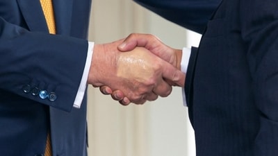 Make-up partially covers the back of the right hand of President Trump as he shakes hands with Bahrain's Crown Prince Salman bin Hamad Al Khalifa. (REUTERS)