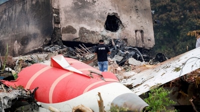 A firefighter stands next to the crashed Air India Boeing 787 Dreamliner aircraft, in Ahmedabad. (Reuters)