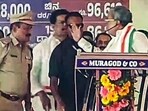 Karnataka Chief Minister Siddaramaiah angrily calls a Police officer on stage and gestures raising his hand at him during Congress' protest rally, in Belagavi. (ANI Photo) Karnataka Chief Minister Siddaramaiah angrily calls a Police officer on stage and gestures raising his hand at him during Congress' protest rally, in Belagavi. (ANI Photo)