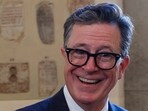 Stephen Colbert, a notable figure in TV satire with a net worth of $75 million, gained fame through The Daily Show and The Colbert Report. (AP Photo/Kevin Wolf, Riccardo De Luca)
