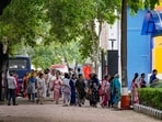 Staff members of the Navy Children School assemble in an area after a bomb threat at Chanakyapuri area, in New Delhi, Monday.