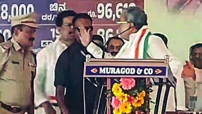 Karnataka Chief Minister Siddaramaiah angrily calls a Police officer on stage and gestures raising his hand at him during Congress' protest rally, in Belagavi. (ANI Photo) (Video Grab) Karnataka Chief Minister Siddaramaiah angrily calls a Police officer on stage and gestures raising his hand at him during Congress' protest rally, in Belagavi. (ANI Photo) (Video Grab)