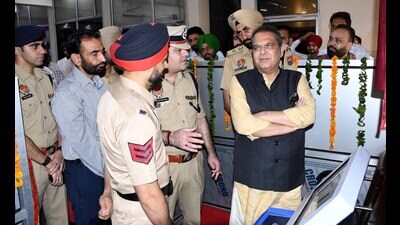 Cabinet minister Sanjeev Arora interacting with police officials about the cyber kiosk machine in Ludhiana on Friday. (HT Photo)