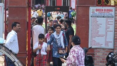 Parents leave with their children after being alerted by the school about the threat mail. (Sonu Mehta/HT Photo)