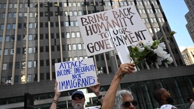 People hold up signs outside an immigration court during a protest as part of the 'Good Trouble Lives On' national day of action against the Trump administration (AFP) People hold up signs outside an immigration court during a protest as part of the 'Good Trouble Lives On' national day of action against the Trump administration (AFP)