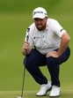 Ireland's Shane Lowry lines up a putt on the first green during the third round. (REUTERS)