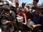 Palestinians gather at a food distribution point in the Nuseirat refugee camp in the central Gaza Strip on July 19, 2025. 