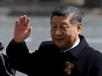 Chinese President Xi Jinping waves to spectators as he leaves after a military parade on Victory Day.