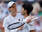 Italy's Jannik Sinner reacts with Spain's Carlos Alcaraz after winning the Wimbledon men's final.