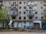 A man stands in front of a damaged apartment building after the shelling, which local Russian-installed authorities called a Ukrainian military strike, in the course of Russia-Ukraine conflict, in Donetsk, Russian-controlled Ukraine, July 19, 2025. 