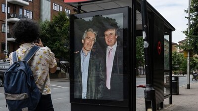 Commuters walk past a bus stop near Nine Elms Station as activists put up a poster showing President Donald Trump and Jeffrey Epstein near the US Embassy in London, Thursday, July 17, 2025. (AP) Commuters walk past a bus stop near Nine Elms Station as activists put up a poster showing President Donald Trump and Jeffrey Epstein near the US Embassy in London, Thursday, July 17, 2025. (AP)