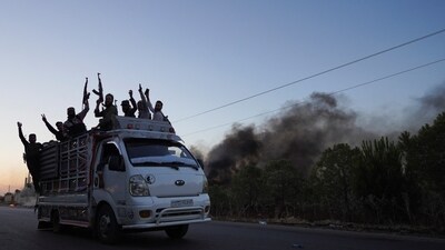 Bedouin fighters ride on a vehicle along a street as Sweida province has been engulfed by nearly a week of violence triggered by clashes between Bedouin fighters and factions from the Druze, at Sweida governorate, Syria, July 18, 2025. (Reuters)