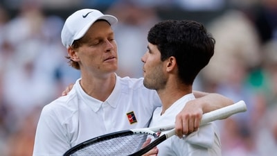 Italy's Jannik Sinner reacts with Spain's Carlos Alcaraz after winning the Wimbledon men's final. (REUTERS)