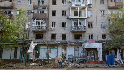 A man stands in front of a damaged apartment building after the shelling, which local Russian-installed authorities called a Ukrainian military strike, in the course of Russia-Ukraine conflict, in Donetsk, Russian-controlled Ukraine, July 19, 2025. (REUTERS)