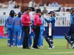 England's Tammy Beaumont speaks to the umpire after India appeal for obstructing the field. 