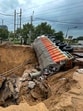Due to heavy rainfall last Wednesday, a portion of the slip road at the intersection of SPR and Sector 75 and 75A road had caved in, and a truck carrying liquor had got stuck in a very large cavity. Heavy congestion and traffic jams were witnessed for the next three to four days on this section of the road. (HT PHOTO)