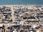 Tents and shelters for Palestinians displaced by conflict are pictured erected at a make-shift camp along the beach near the seaport in the west of Gaza City on July 19, 2025.