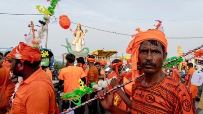 Kanwariyas carry holy water from river Ganga in plastic bottle as they walk towards temple after holy dips in Prayagraj. (AP) Kanwariyas carry holy water from river Ganga in plastic bottle as they walk towards temple after holy dips in Prayagraj. (AP)