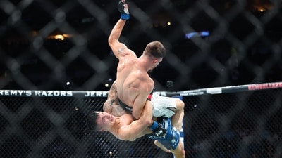 Jul 19, 2025; New Orleans, Louisiana, UNITED STATES; Francisco Prado (red gloves) fights against Nikolay Veretennikov (blue gloves) during UFC 318 at Smoothie King Center. (Stephen Lew-Imagn Images via Reuters Connect)