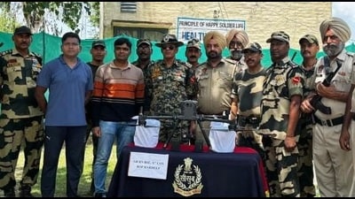 Officials with the seized drone and other items in Tarn Taran on Sunday. (HT)
