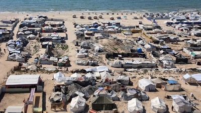 Tents and shelters for Palestinians displaced by conflict are pictured erected at a make-shift camp along the beach near the seaport in the west of Gaza City on July 19, 2025. (AFP)