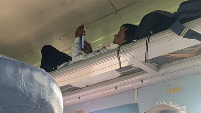A man used the luggage rack as a bed during a train ride, and the image quickly spread online. (Reddit/AGuywithBigMouth) A man used the luggage rack as a bed during a train ride, and the image quickly spread online. (Reddit/AGuywithBigMouth)