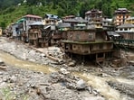 Debris and slit near damaged houses at a flood-affected area, in Mandi district.