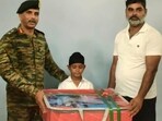 Lt Gen Manoj Kumar Katiyar, GOC-in-C Western Command, felicitating Shravan Singh in Ferozepur on Saturday. (HT)