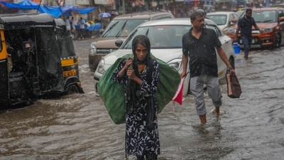 A ragpicker walks through a flooded street as it rains in Mumbai, India, Monday, July 21, 2025. (AP) A ragpicker walks through a flooded street as it rains in Mumbai, India, Monday, July 21, 2025. (AP)