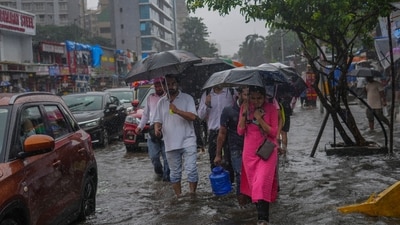 People walk through a water logged street during a rain in Mumbai, India, Monday, July 21, 2025. (AP) People walk through a water logged street during a rain in Mumbai, India, Monday, July 21, 2025. (AP)