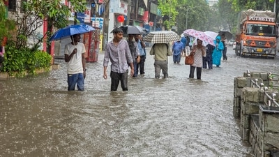  People wade through a waterlogged road amid rain, in Mumbai, Maharashtra, Monday, July 21, 2025. (PTI) People wade through a waterlogged road amid rain, in Mumbai, Maharashtra, Monday, July 21, 2025. (PTI)