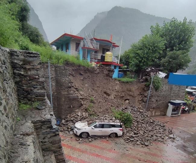 A vehicle buried under the debris after a landslide at a Thalot petrol station in Aut tehsil of Mandi district on Monday. (HT Photo) A vehicle buried under the debris after a landslide at a Thalot petrol station in Aut tehsil of Mandi district on Monday. (HT Photo)